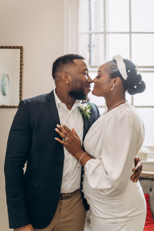 A bride and a groom looking at each other
