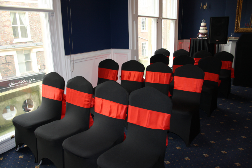 Black wedding chairs with red sash, 4 rows of 4 chairs