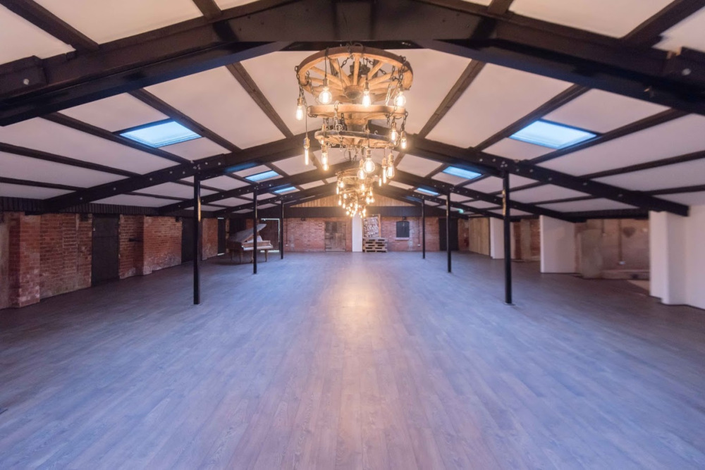 The barn at Deighton Lodge is empty and ready to be prepared for a wedding, this image shows how big the lodge is and the chandeliers have been left in place
