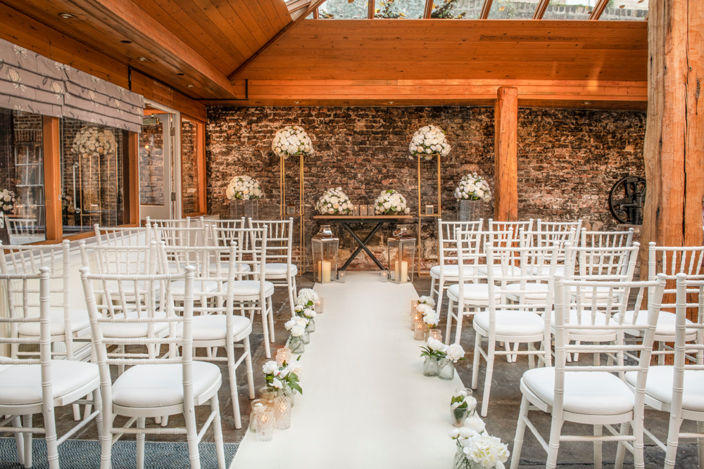 A room in Middleton's Hotel has been prepared for a wedding with chairs lining the aisle and facing the altar